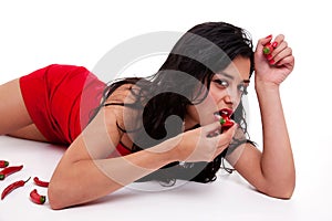 Beautiful and seductive woman lying with chili