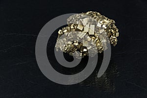 Beautiful semi-precious stone pyrite on a black background