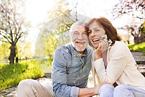 Beautiful senior couple in love outside in spring nature.