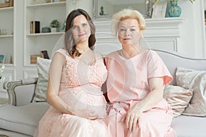 Beautiful senior mom and her adult daughter are hugging