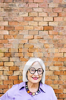 beautiful senior woman with glasses smiling happy