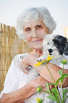 Beautiful senior woman hugging her dog