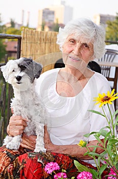 Beautiful senior woman hugging her dog