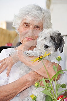 Beautiful senior woman hugging her dog