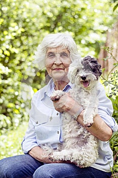 Beautiful senior woman hugging her dog