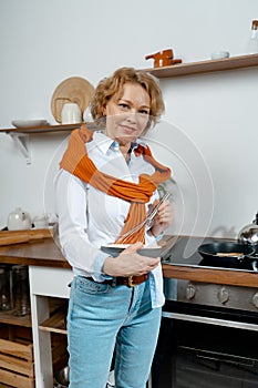 Beautiful Senior Woman Preparing Meal For Her Friends At Rustic Kitchen. Concept Of Having Fun At Any Age