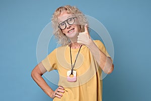 Beautiful senior woman showing thumbs up sign