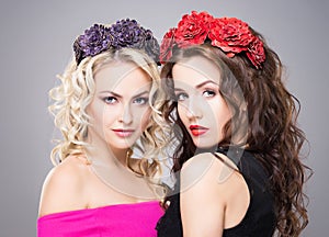 Beautiful, sensual blond and brunette wearing flower alike coronets