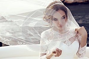 Beautiful sensual bride with dark hair in luxurious lace wedding dress