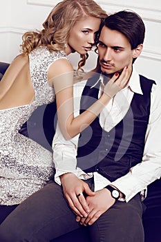 Beautiful sensual couple in elegant clothes posing in studio