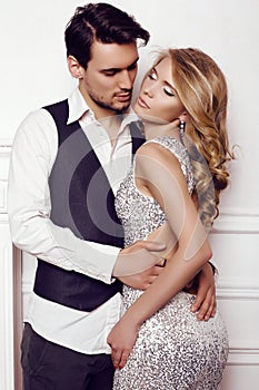 Beautiful sensual couple in elegant clothes posing in studio