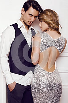 Beautiful sensual couple in elegant clothes posing in studio