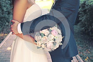 Beautiful sensual wedding couple and gentle bouquet of flowers