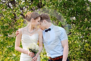 Beautiful sensual wedding couple and gentle bouquet of flowers