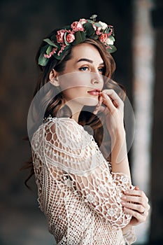 Beautiful sensual woman portrait with wreath of flowers in her hair