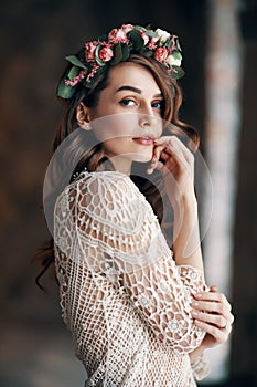 Beautiful sensual woman portrait with wreath of flowers in her hair