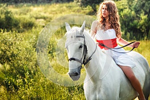 Beautiful sensual women riding on white horse