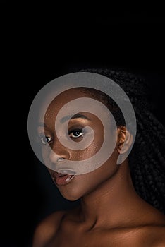 beautiful sensual young african american woman with water drops on face looking away