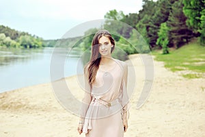 Beautiful sensual young girl walking on the beach