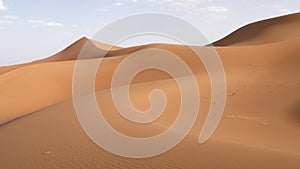 Beautiful serene desert sand dunes landscapes in the Sahara desert, Mhamid, Erg Chigaga, Morocco.