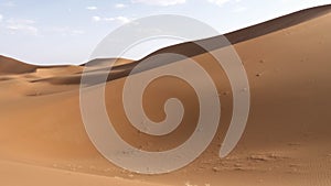 Beautiful serene desert sand dunes landscapes in the Sahara desert, Mhamid, Erg Chigaga, Morocco.