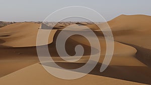 Beautiful serene desert sand dunes landscapes in the Sahara desert, Mhamid, Erg Chigaga, Morocco.