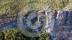 Beautiful serial over the rocks above the bank of a winding river