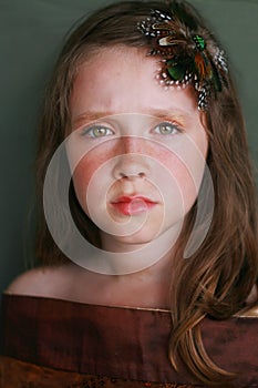 Beautiful serious young girl with pensive gaze