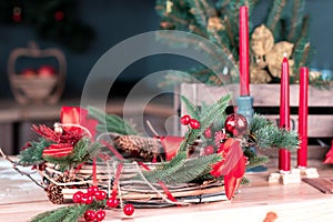 Beautiful served dining table with decorations, red candles and lanterns, Christmas tree blurred background, festive mood