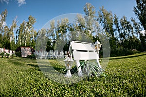 Beautiful setting for outdoors wedding ceremony waiting for bride and groom and guests. White chairs decorated with