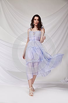 Beautiful sexy brunette woman wear summer collection dress style cruise collection fashion model silk textile elegant clothes