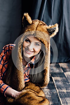 Beautiful girl wearing brown fur hat