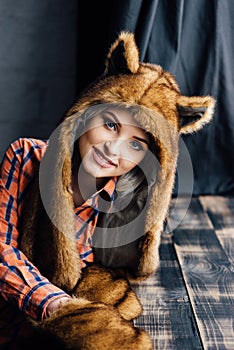 Beautiful girl wearing brown fur hat