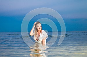 Beautiful girl in a white bathing suit and tunic