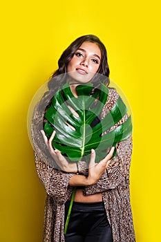 Beautiful indian woman in bikini with tropical plants. Beauty, fashion. Spa, healthcare. Tropical vacation.