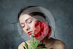 Beautiful sexy stylish young adult in elegant dress with nice bouquet of pink peonies. Studio retouched shot