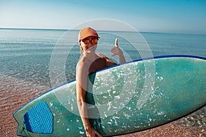 Beautiful surfer girl on the beach