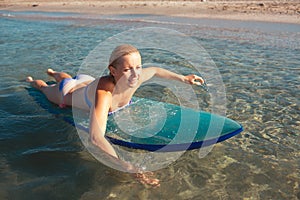 Beautiful surfer girl on the beach