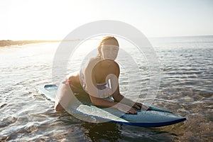 Beautiful surfer girl on the beach