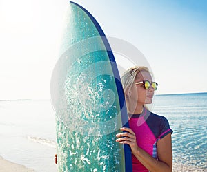 Beautiful surfer girl on the beach