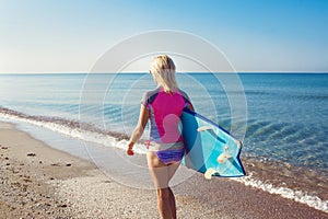 Beautiful surfer girl on the beach