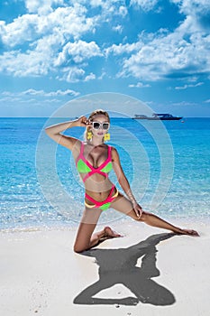 Beautiful sexy tanned woman bikini model on Maldives island. Young glamour girl in swimsuit on Maldives beach. Perfect body bikini