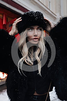 beautiful sexy woman with blond hair wearing elegant fur coat and hat in slavic style