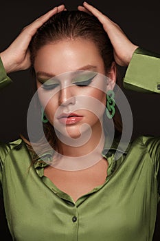 Beautiful sexy woman with classic make-up, fashion hair and green eyes. Beauty face. Photo taken in the studio.