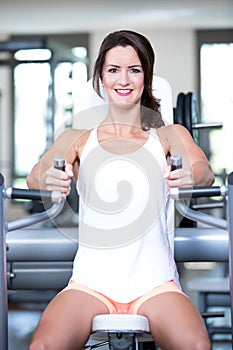 Beautiful woman man couple are doing a workout in the fitnes gym - chest press, bench