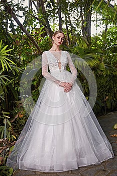 Beautiful sexy woman model bride wearing white long silk and lace wedding dress fashion espousal bright makeup hairstyle blond