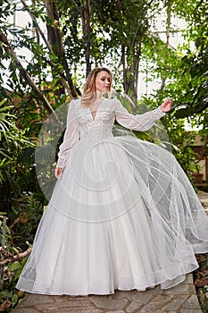 Beautiful sexy woman model bride wearing white long silk and lace wedding dress fashion espousal bright makeup hairstyle blond photo