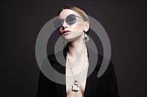 Beautiful sexy woman in sunglasses and jewelry