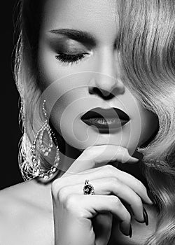 Beautiful sexy woman with vintage make-up and hairstyle. Diva of cinematograph in black and white noir. American style