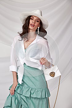 Beautiful sexy woman wear light blue color dress summer collection cotton casual style accessory hat shirt tanned body brunette